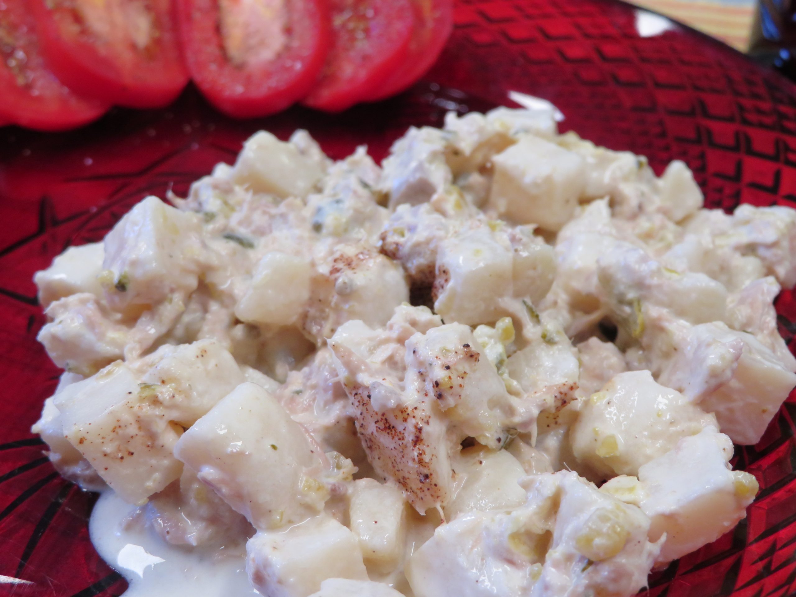 Tuna Potato Salad on a plate with sliced tomatoes