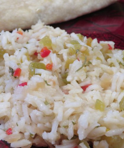 Green chile rice on a red plate