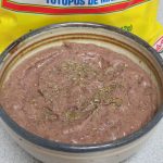 Bowl of Black Bean Dip in front of a bag of tortilla chips