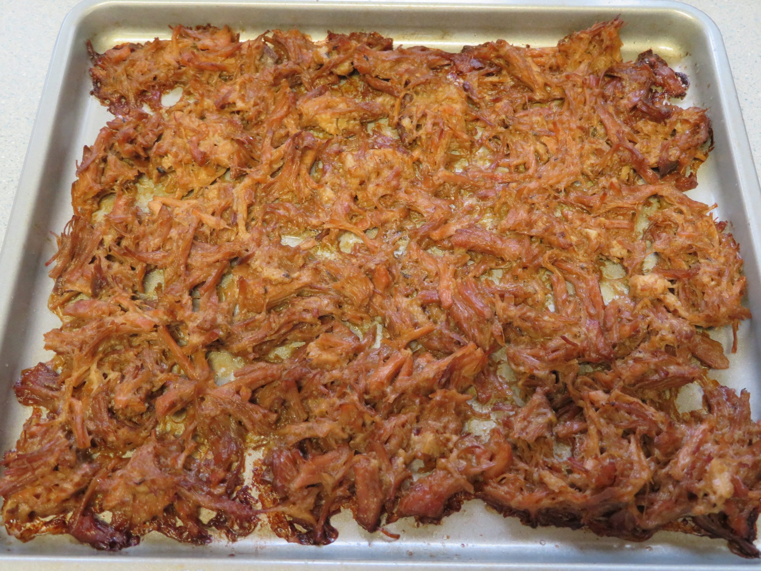 Roasted carnitas on a baking pan