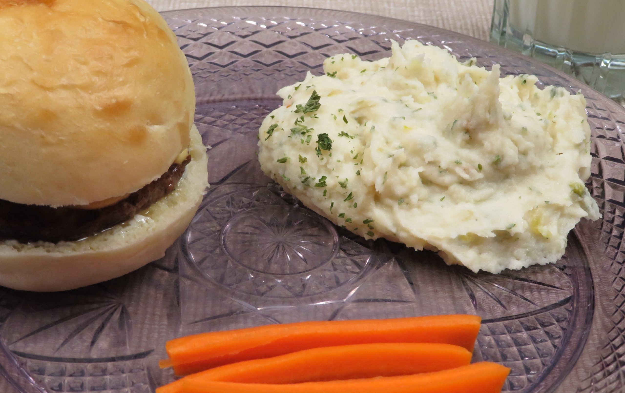 Mashed Potato Salad on a plate with a hamburger and carrot sticks