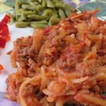 Hamburger Hashbrown Casserole on a plate with vegetables