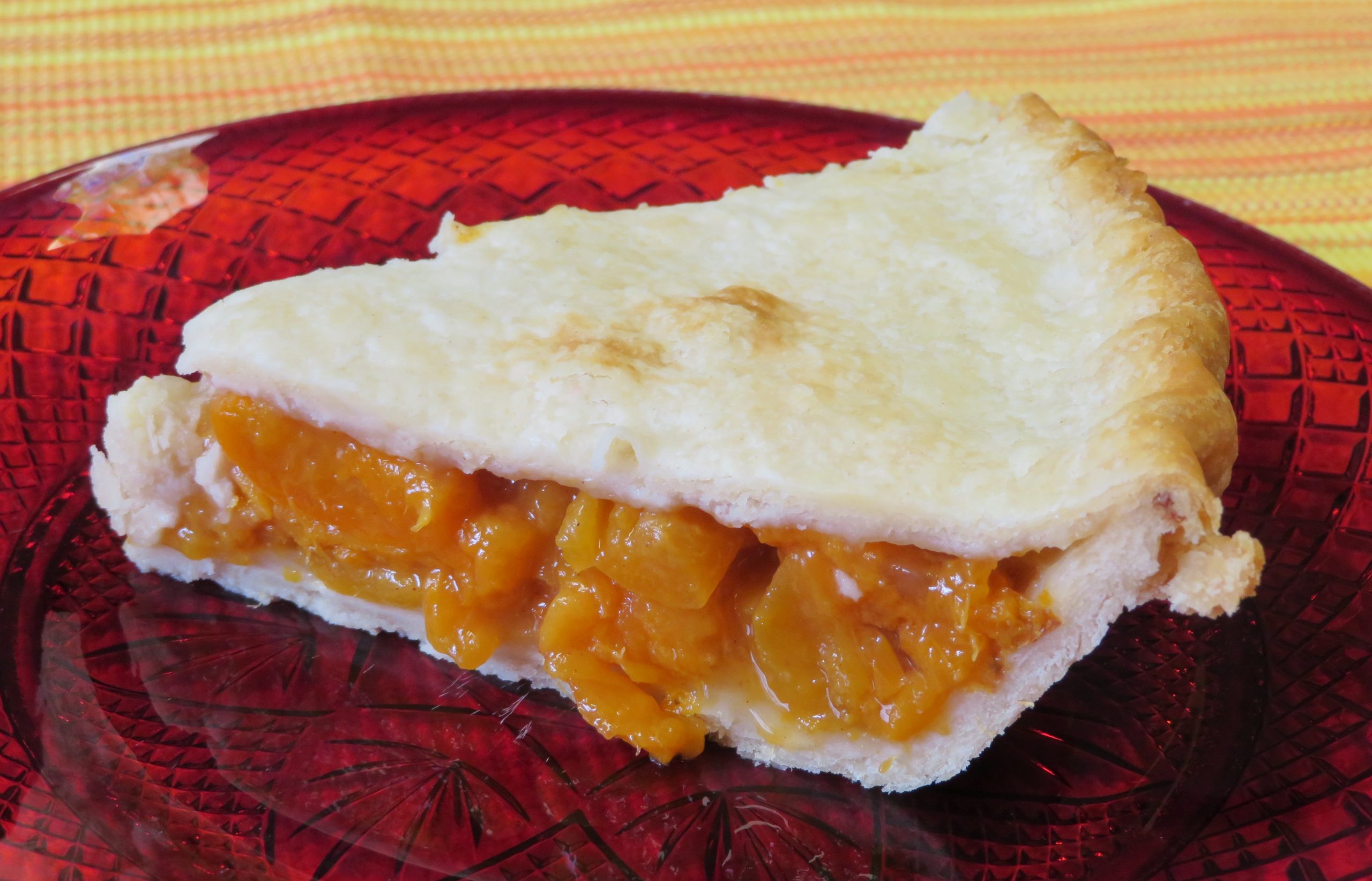 A slice of apricot pie on a plate