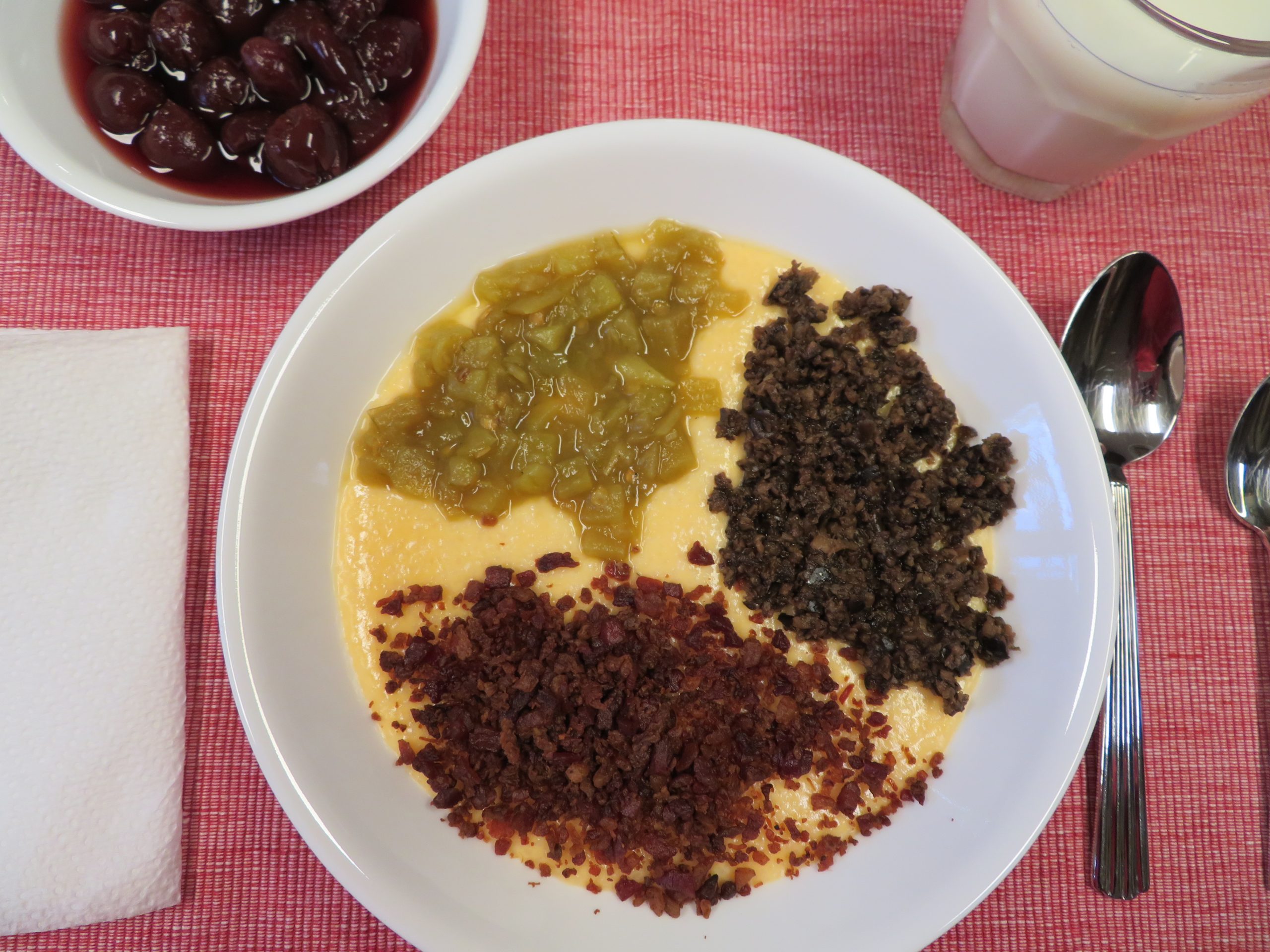 Cheese Grits Bowl with green chiles, chopped black olives, and crumbled bacon