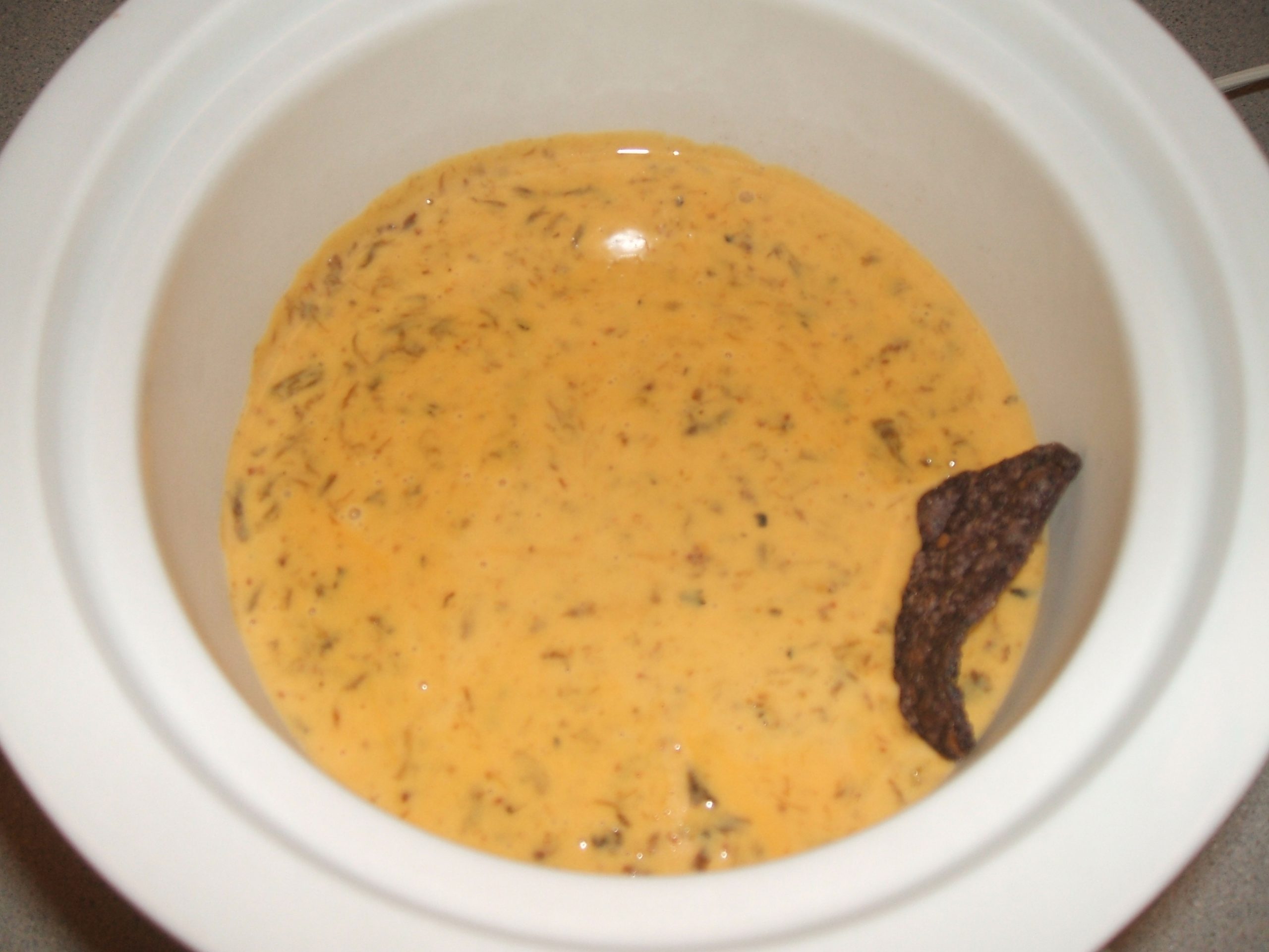 Green Chile Queso in a small slow cooker