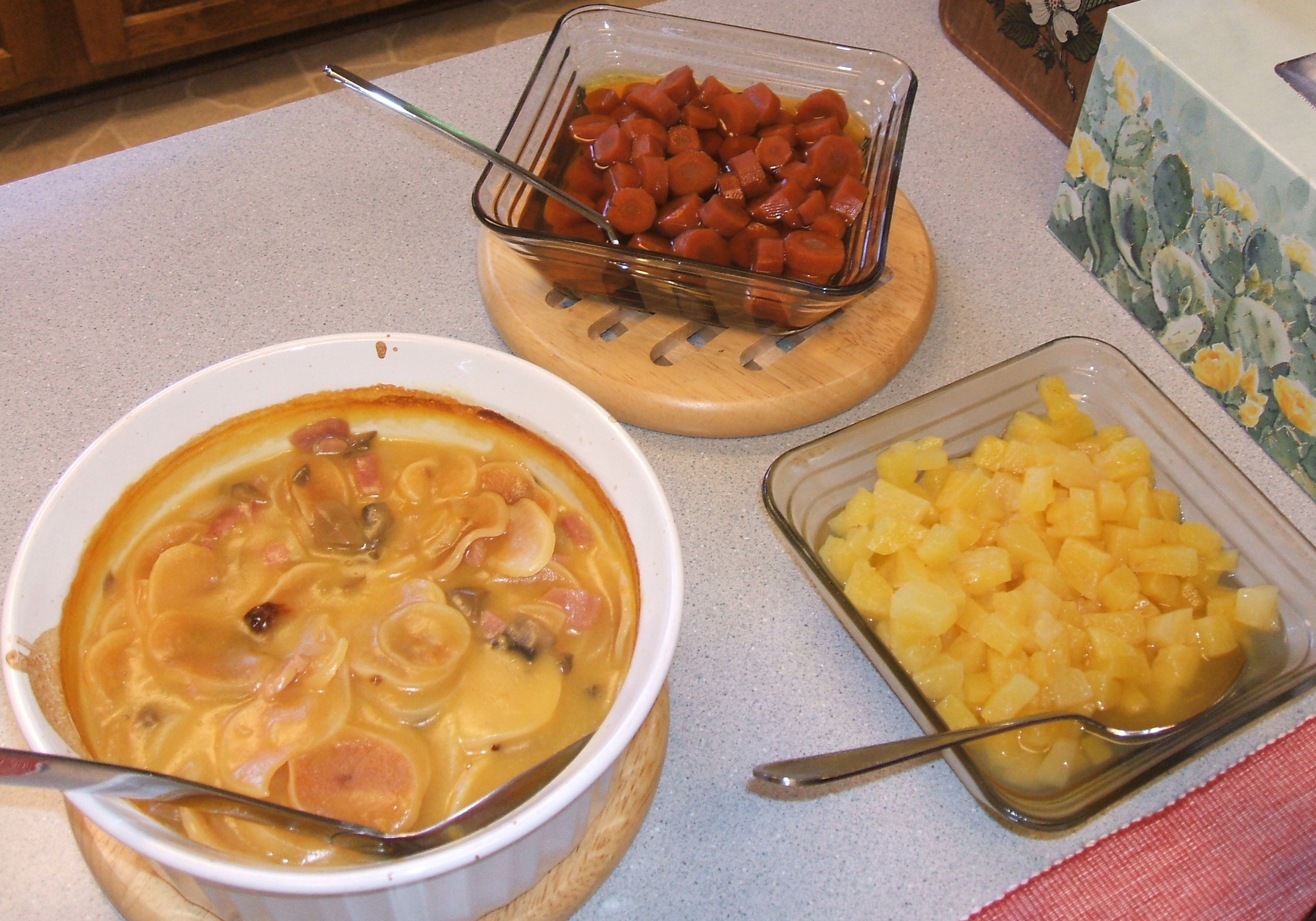 Home storage dinner of ham and potato casserole, brown sugar carrots, and pineapple tidbits