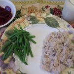 Creamy chicken and mushroom rice and green beans on a plate with pickled beets in a bowl and milk in a glass