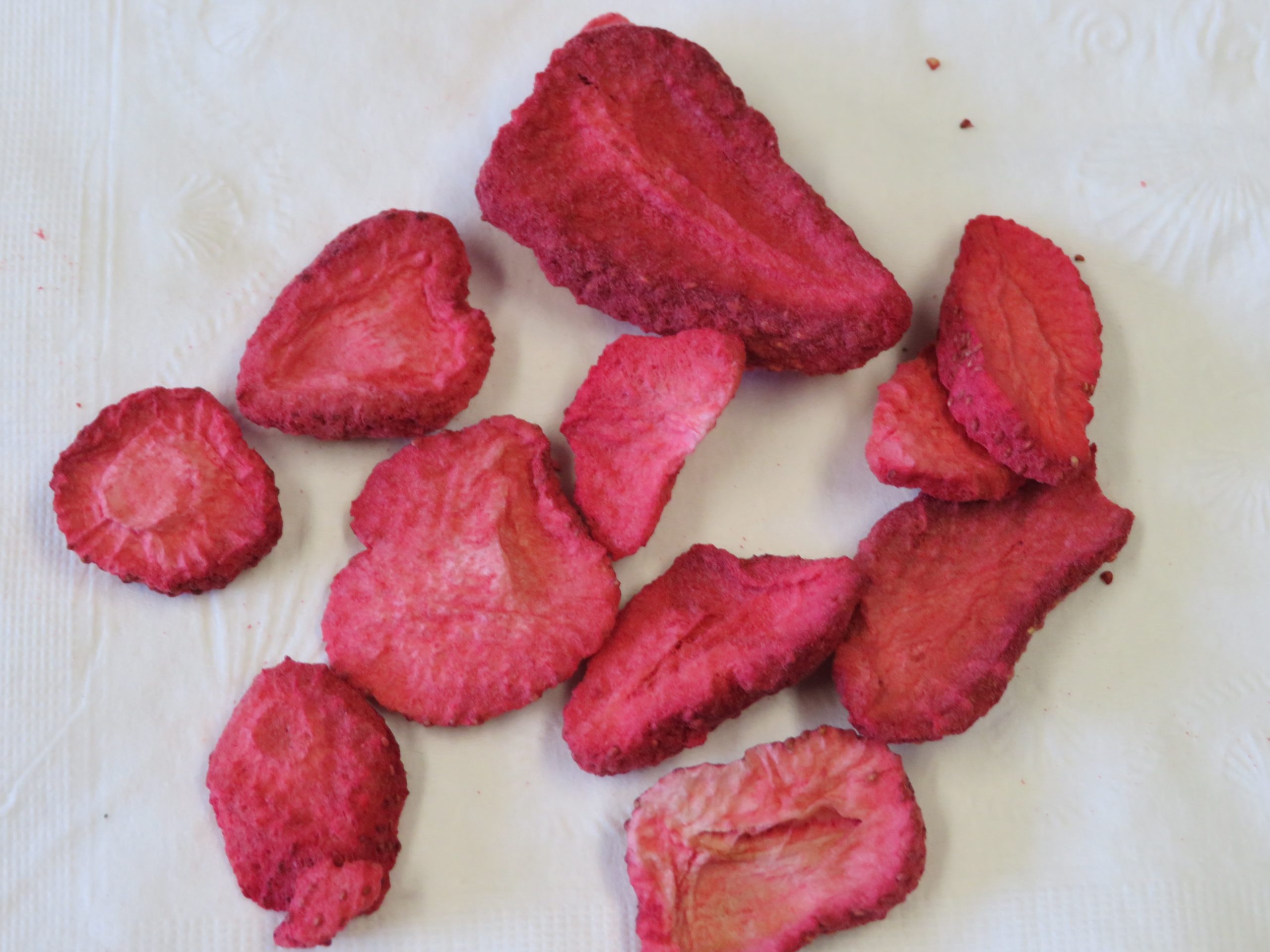 Freeze dried aliced strawberries spread on a napkin