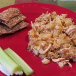 Tropical Pineapple Chicken Salad on a red plate with celery and crisp bread