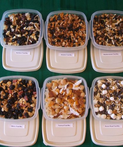 Six trail mixes in labeled plastic containers