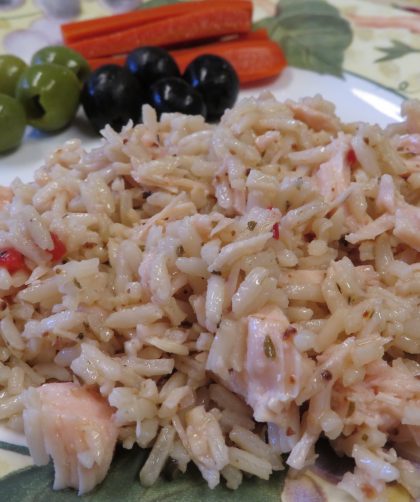 Herbed Rice and Chicken Salad on a plate with olives and red peppers