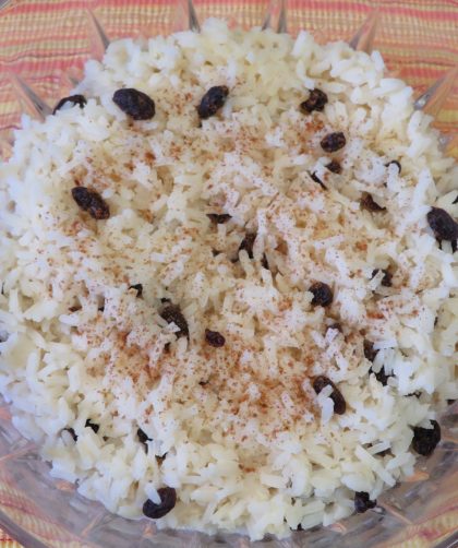 Quick Rice Pudding with raisins topped with cinnamon in a cut glass bowl