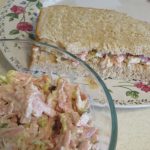 Dill Spam Salad in a glass bowl and a sandwich on a floral edged plate