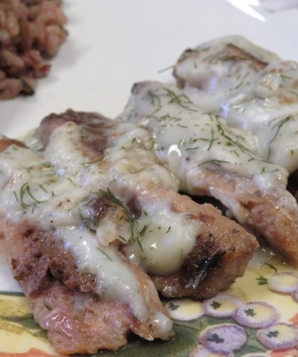 Baked Sardines with Dill Sauce on a plate with whole grain rice