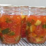 Pint jars of home canned tomatoes and zucchini