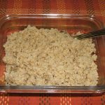 A clear square bowl of Herb Seasoned Quinoa