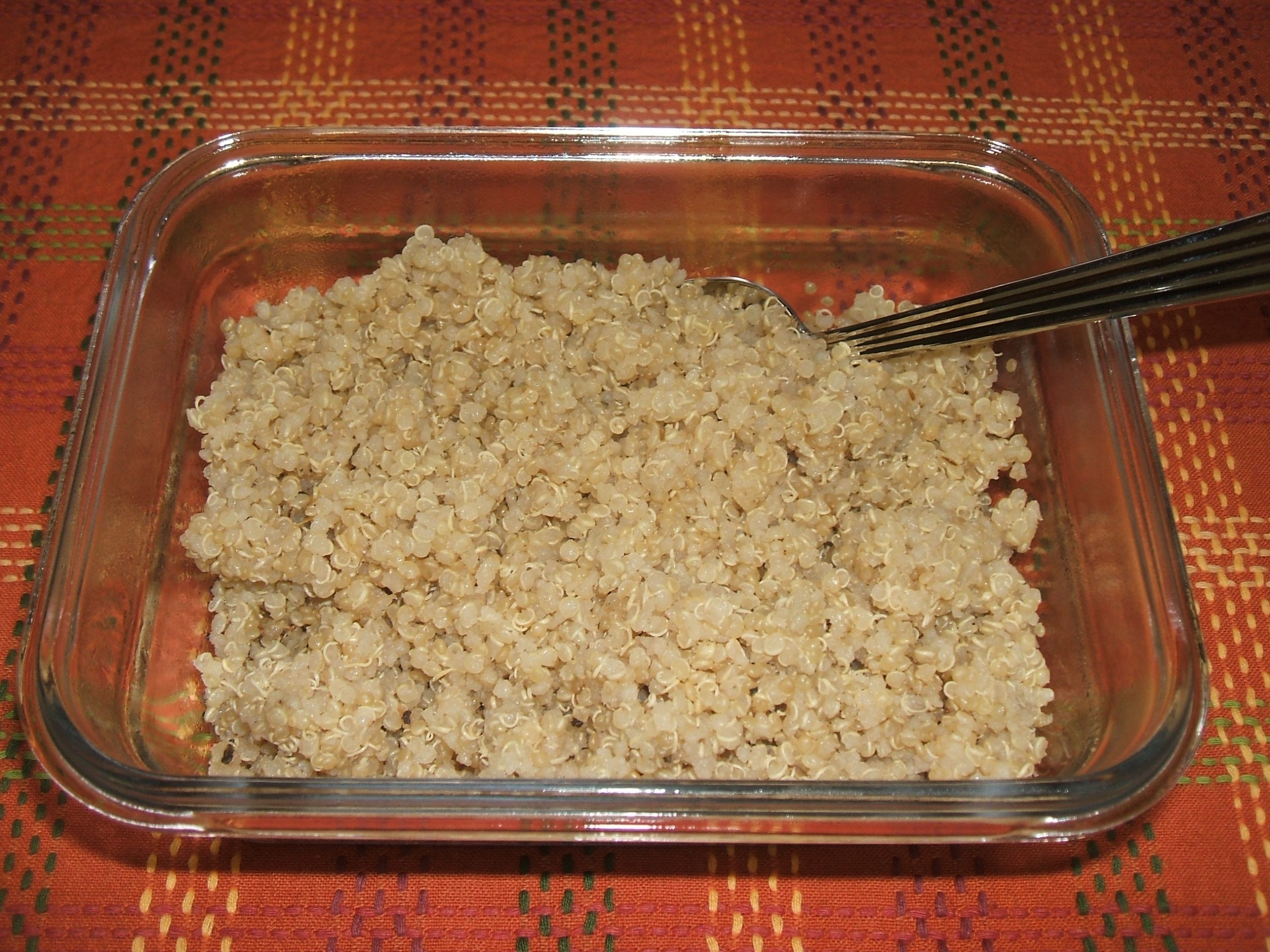 A clear square bowl of Herb Seasoned Quinoa