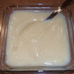 A square glass bowl filled with Spiced Pear Sauce