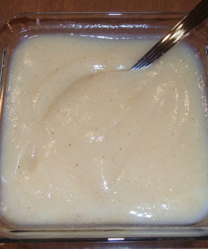 A square glass bowl filled with Spiced Pear Sauce