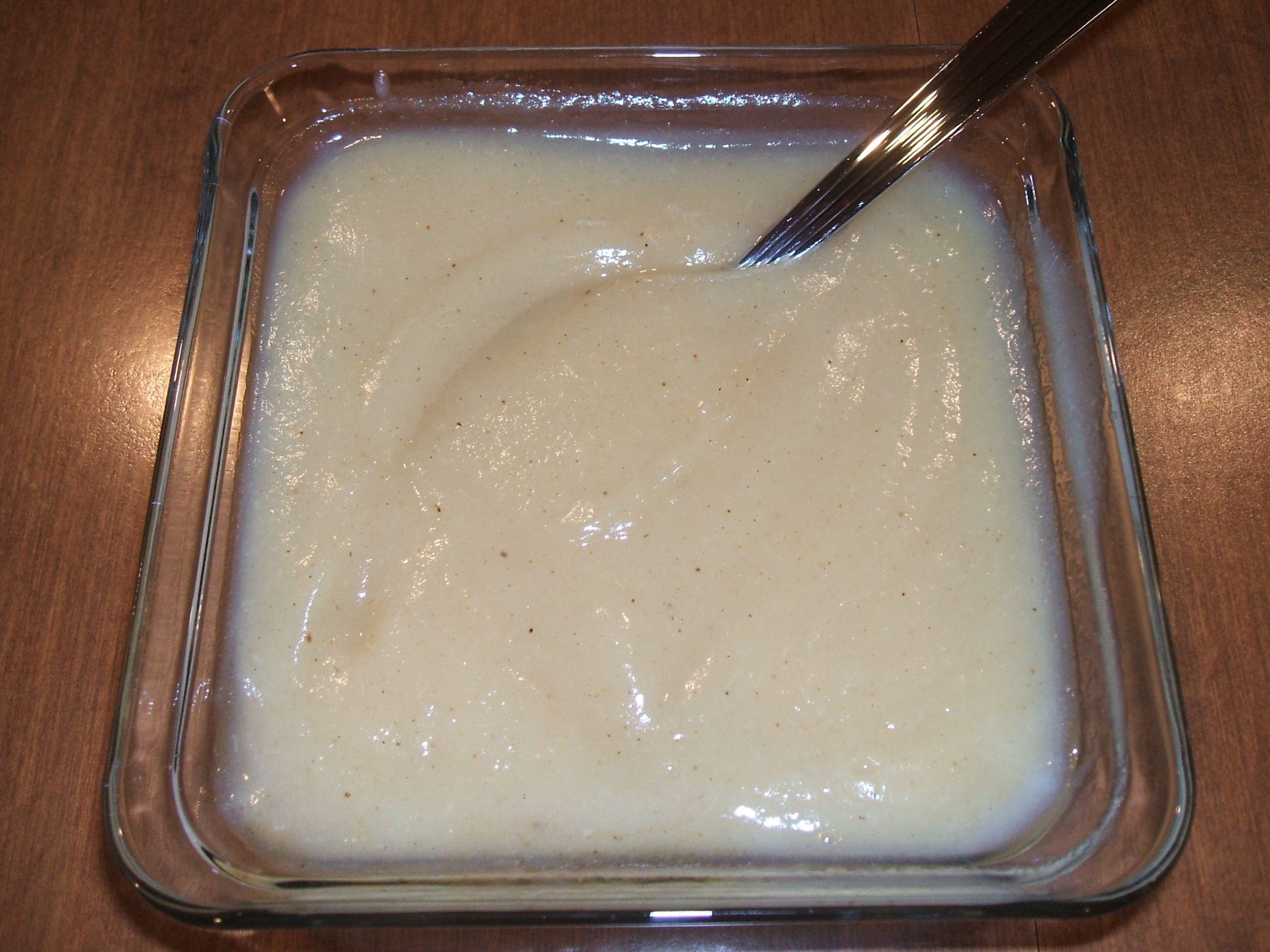 A square glass bowl filled with Spiced Pear Sauce